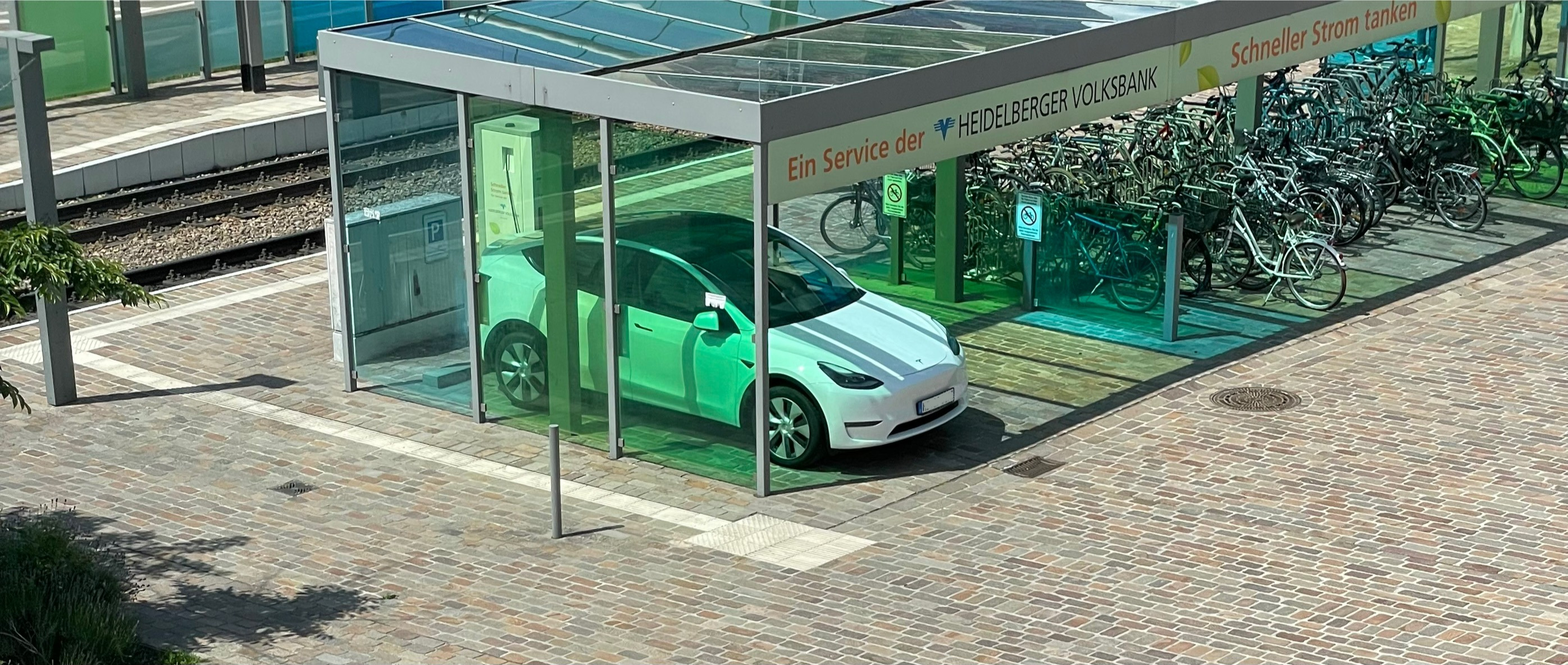 White Tesla Model Y Charging at charging Station